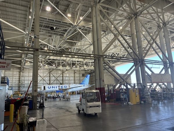 United Airlines maintenance hangar interior with structural high-bay lighting