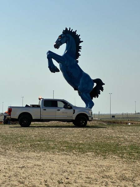An EVO service truck on site at Denver International Airport beside the Blue Mustang sculpture