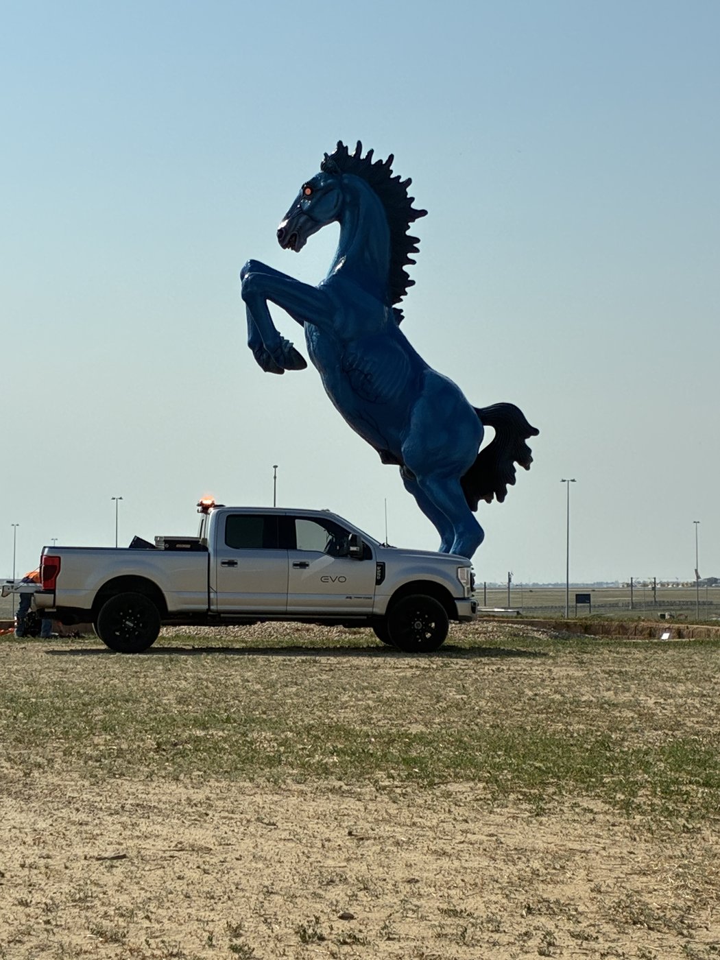 An EVO service truck on site at Denver International Airport beside the Blue Mustang sculpture